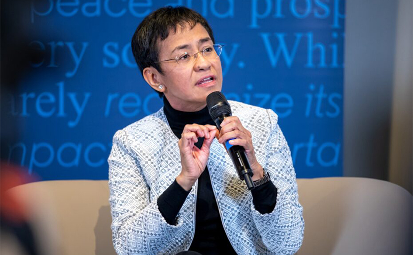 Maria Ressa speaking at a panel discussion.