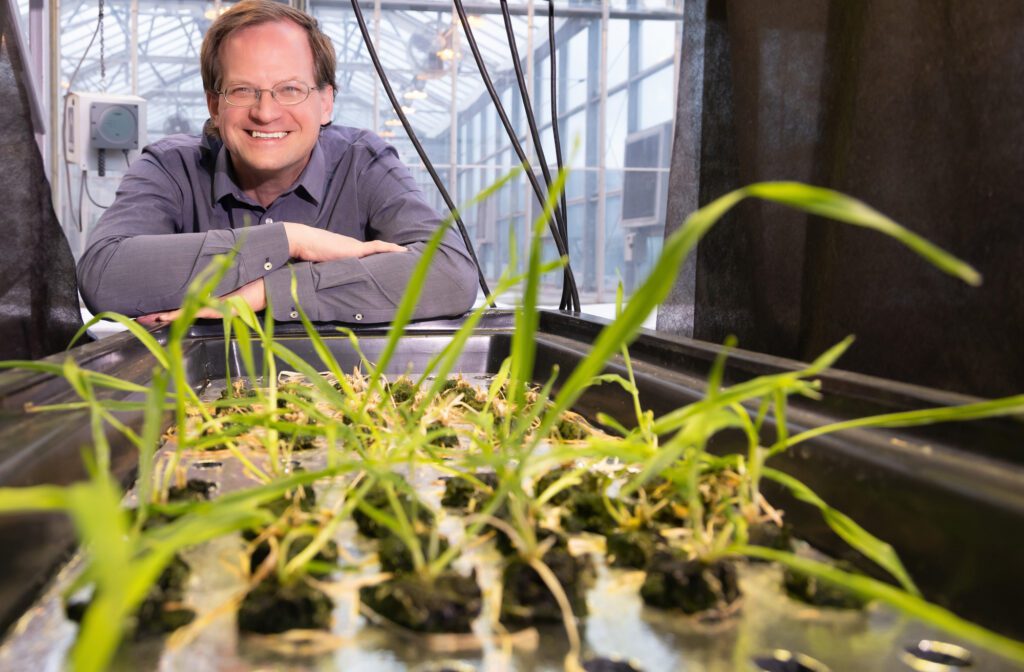 Mark Lefrud smiling in front of a planter.