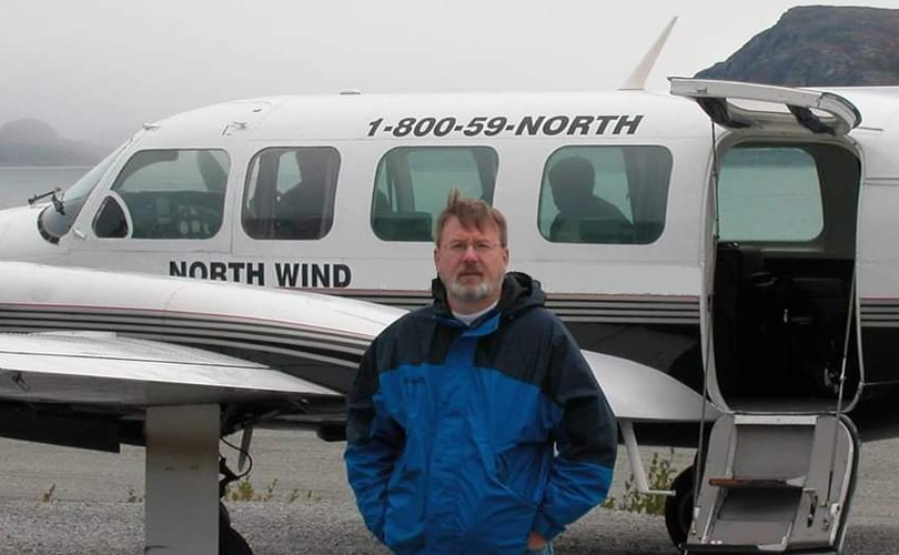 Gregory Jones standing in front of a small passenger plane.